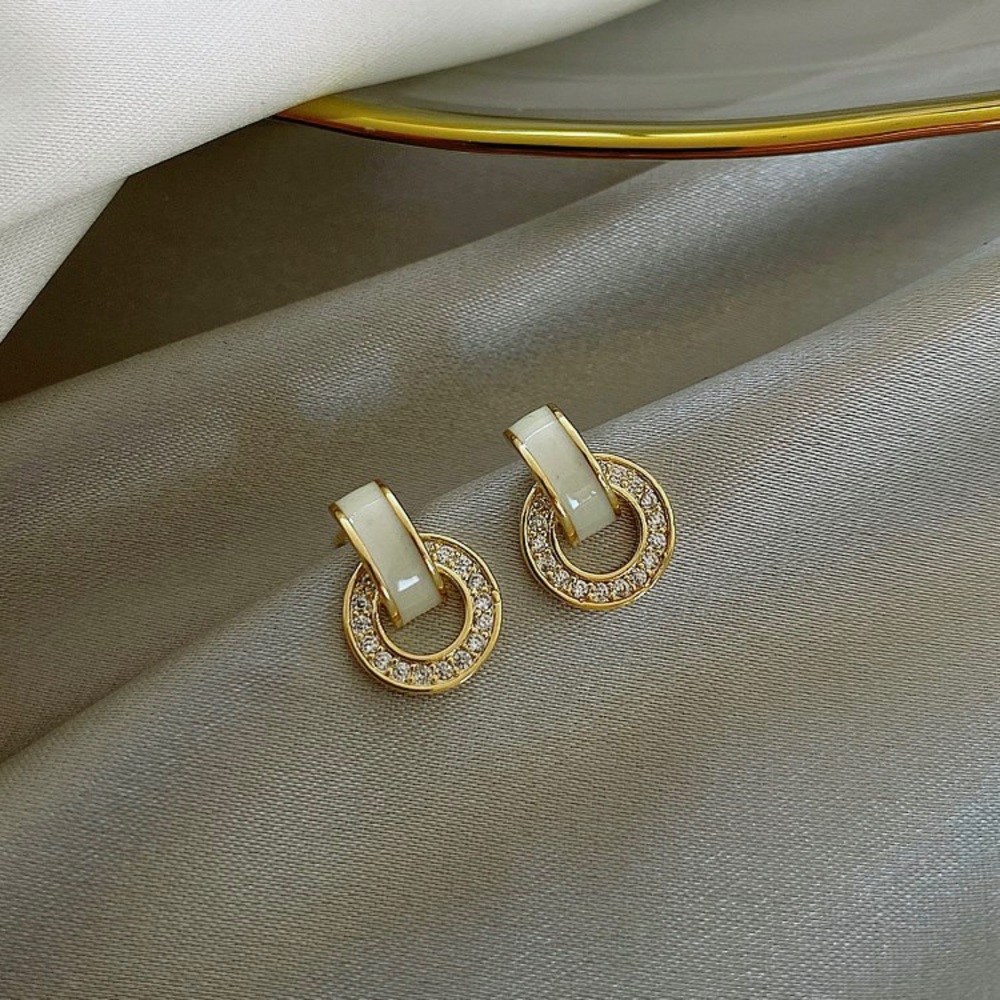 Round gold earring with rhinestone